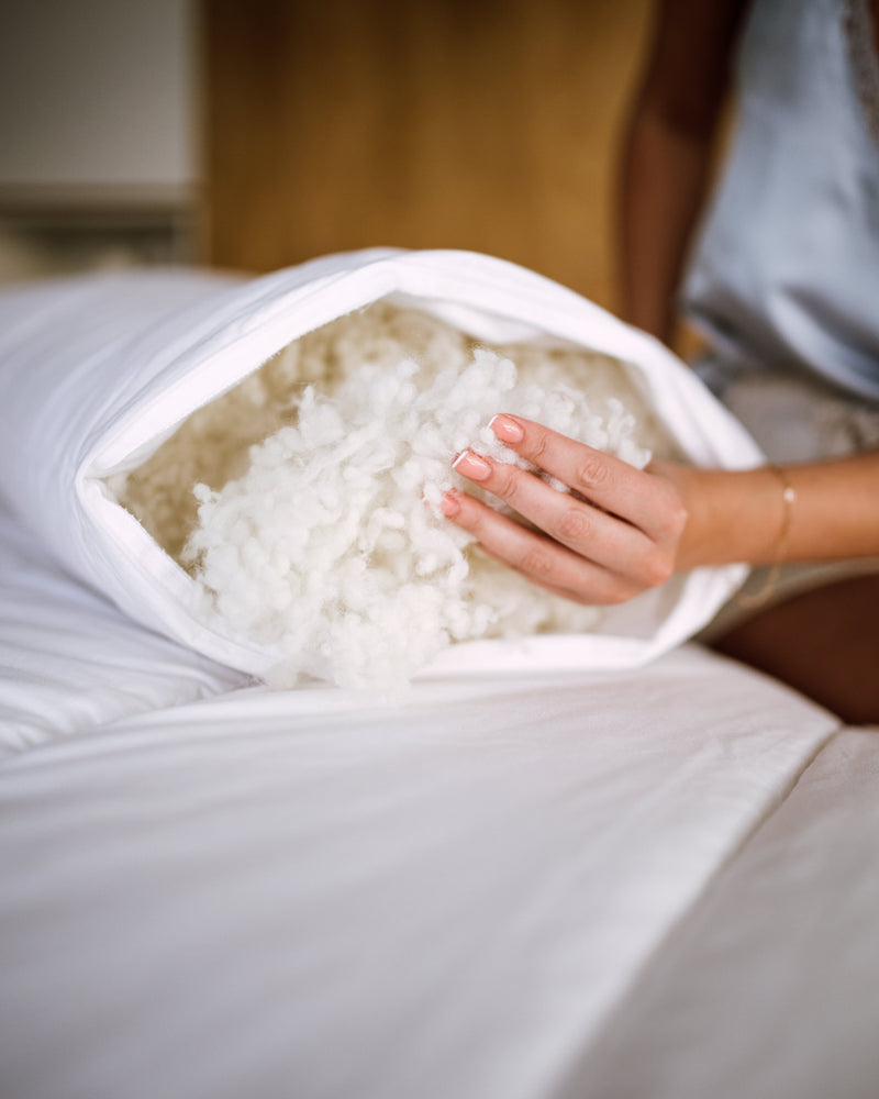 Lora & Flok wool pillow unzipped showing the natural NZ wool filling.