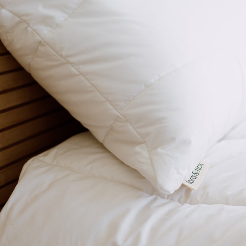 Cotton and wool quilted bed pillow shell filled with New Zealand wool by Lora & Flok. 